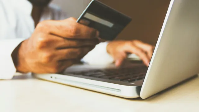 Persona usando una laptop con tarjeta en mano para comprar en una tienda en línea, ejemplo de ecommerce en México